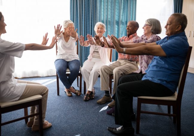 female-doctor-and-seniors-exercising-on-chairs.jpg
